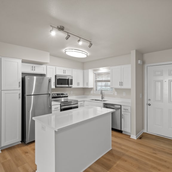 Thumbnail 3 of 13 an open kitchen with a large island and stainless steel appliances