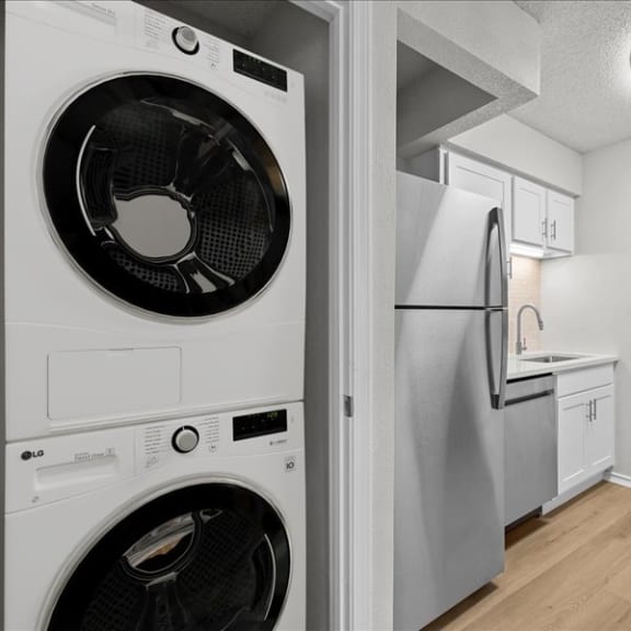Thumbnail 10 of 13 a white kitchen with a washing machine and a refrigerator