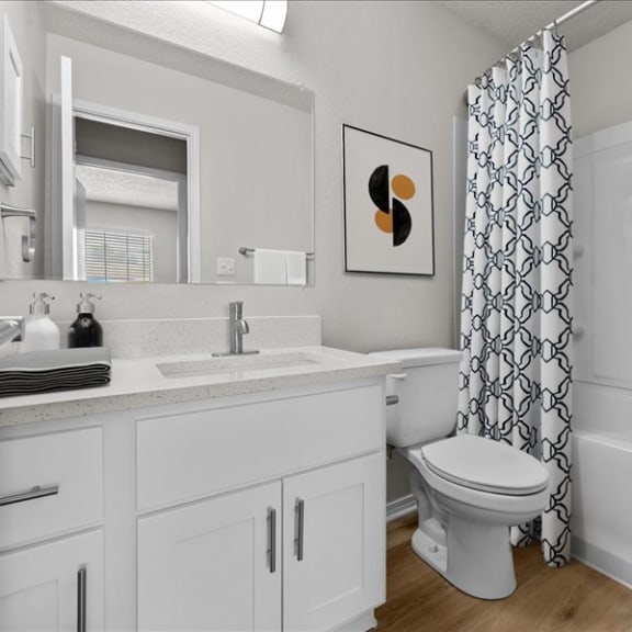 Thumbnail 6 of 13 a bathroom with a toilet and a sink and a shower