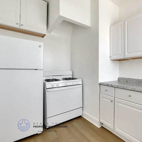 a kitchen with white appliances and cabinets.