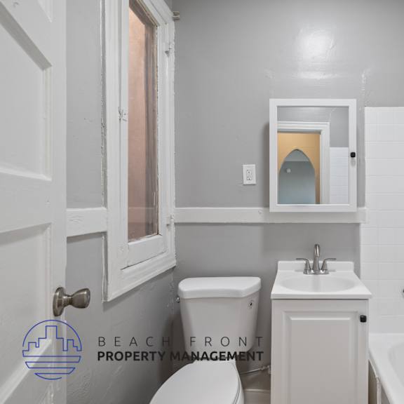 a white bathroom with a sink toilet and a tub
