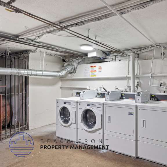 an image of a laundry room with four washing machines in it