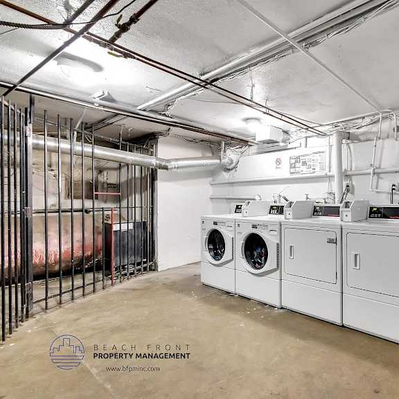 a laundry room with washers and dryers.