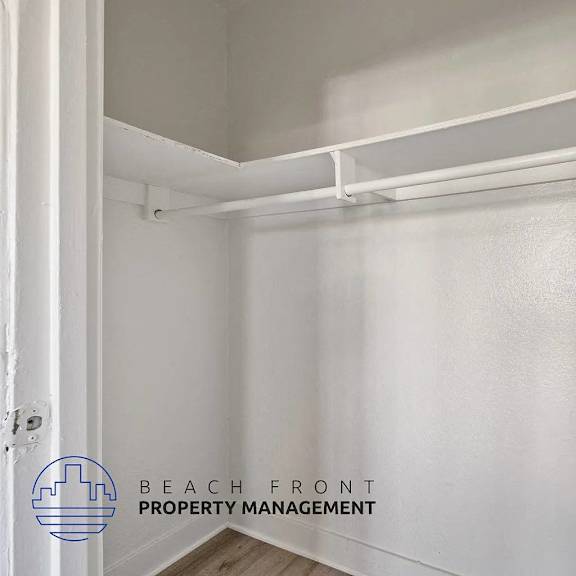 a white empty pantry with a logo of beach front property management.