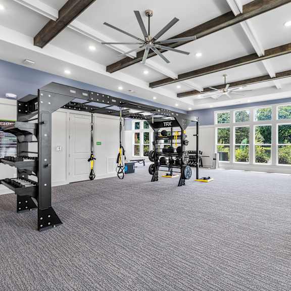 an empty bedroom with a bed and a ceiling fan