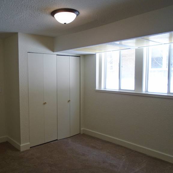 a bedroom with a closet and a window