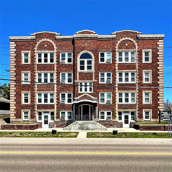 a red brick building with a blue sky in the background