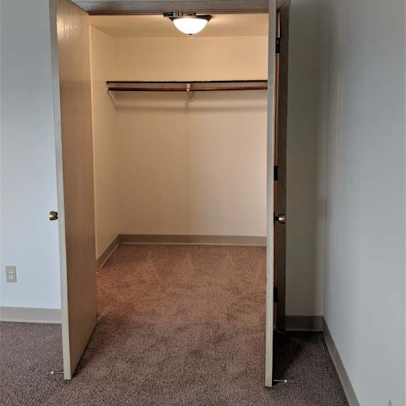 photo of open closet with shelf at john snell apartments