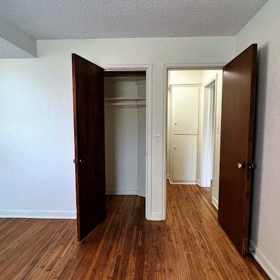 a living room with hardwood floors and white walls