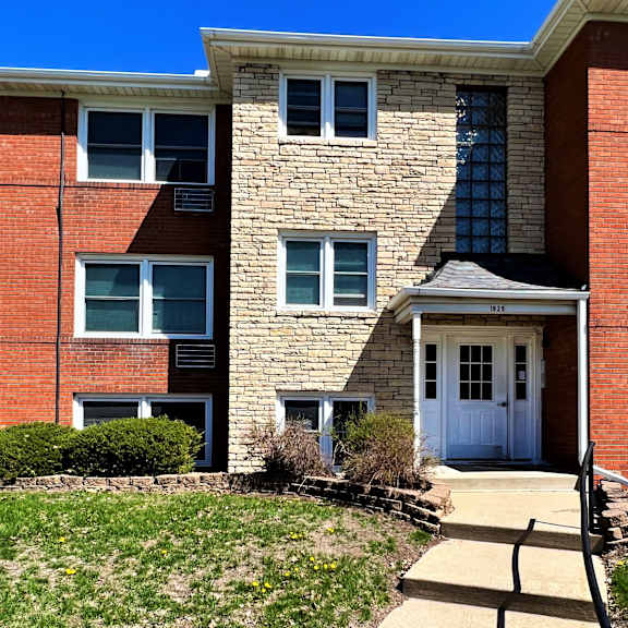 a walkway leads to the front door of an apartment building