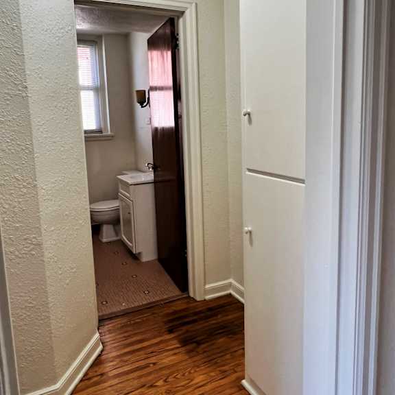 a small bathroom with a toilet and a window