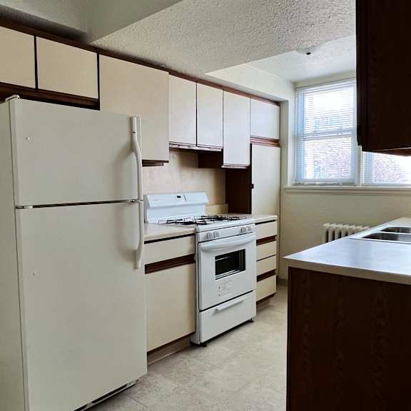 a kitchen with white appliances and white cabinets
