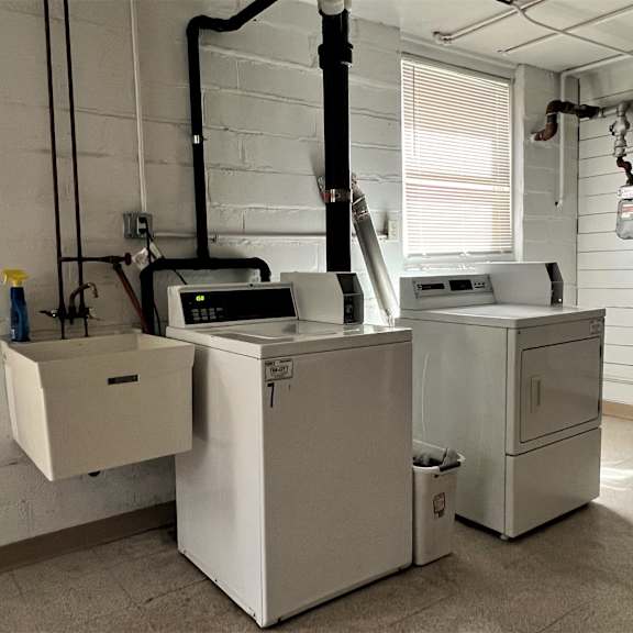 a laundry room with two washing machines and a washer and dryer