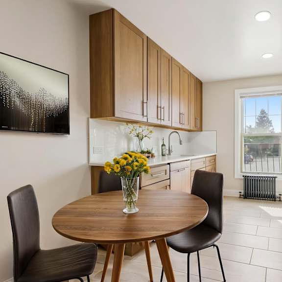 a modern kitchen with a table and chairs.