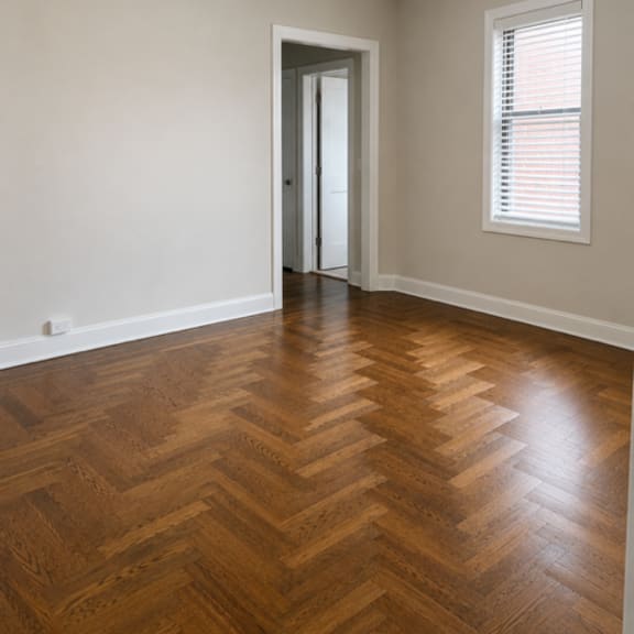 a room with a wooden floor and a ceiling fan.