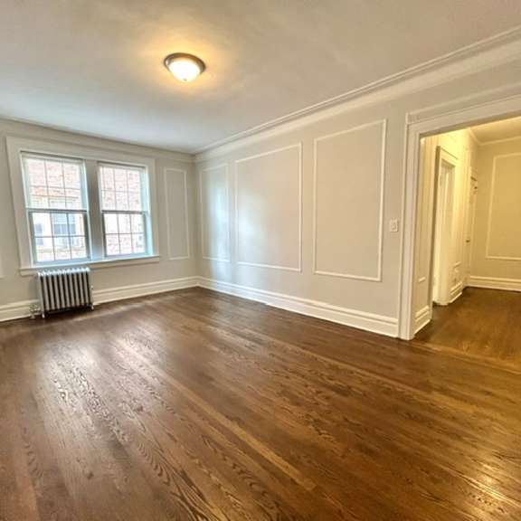 a room with wooden floors and white walls.
