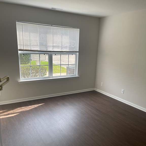 a window with blinds is open, letting in light.