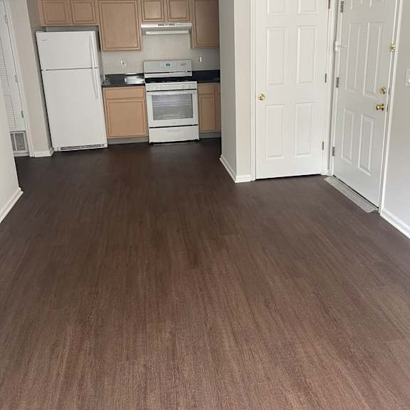 a kitchen with brown walls and white cabinets.