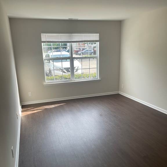 a room with a window and a wooden wall.