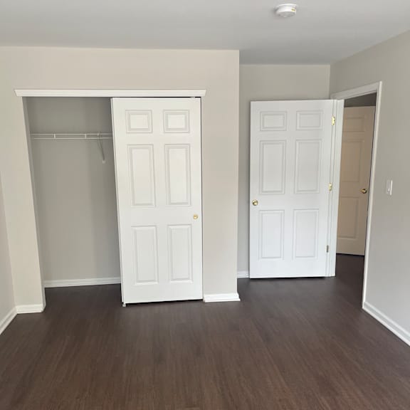 a white cabinet with a shelf is mounted on a wall.