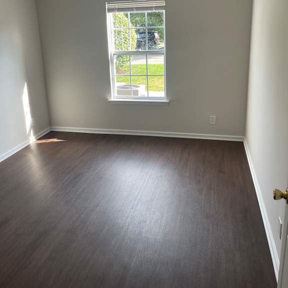 a room with a window and a brown wall.