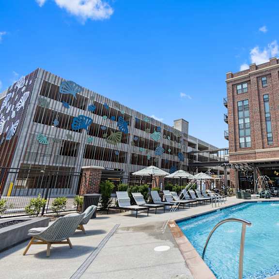 a swimming pool in front of a brick building
