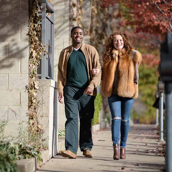 a man and a woman walking down a sidewalk