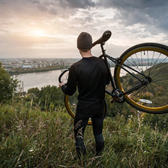 a man standing on a hill with a bike at Solstice at Fiddyment Ranch, Roseville, CA, 95747