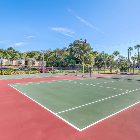 a tennis court at the enclave at woodbridge apartments in sugar land, tx
