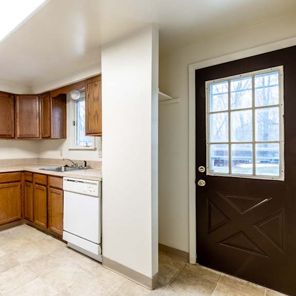 a kitchen with brown cabinets and white appliances.