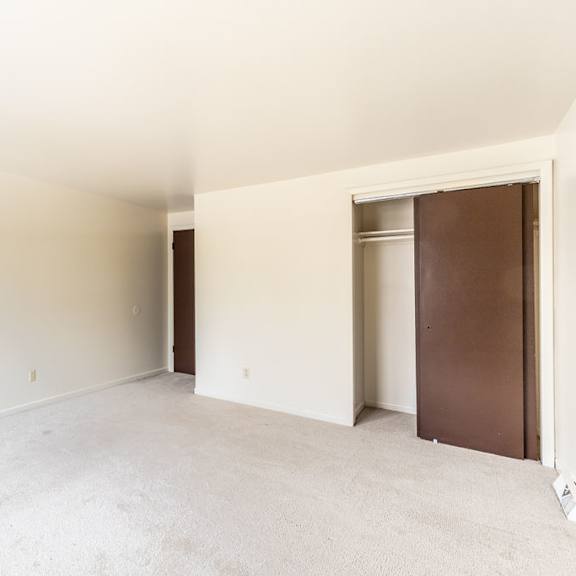 empty room with brown and white walls and carpet.