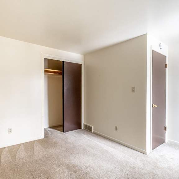 a room with a carpeted floor and a doorway leading to another room.