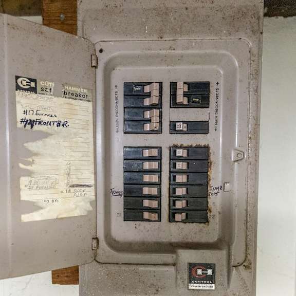 a dirty electrical panel with a label that says