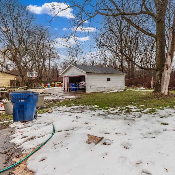 a backyard with a shed and a tree.