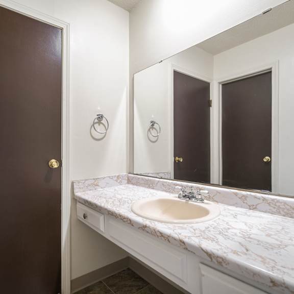 a bathroom with a sink and a mirror.