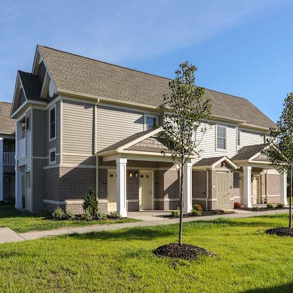 a house with a sidewalk and lawn in front of it