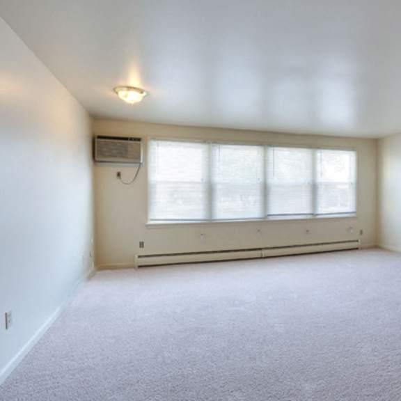 berkley manor apartments - living room – air conditioning unit – natural lighting - ask for a tour - pet friendly