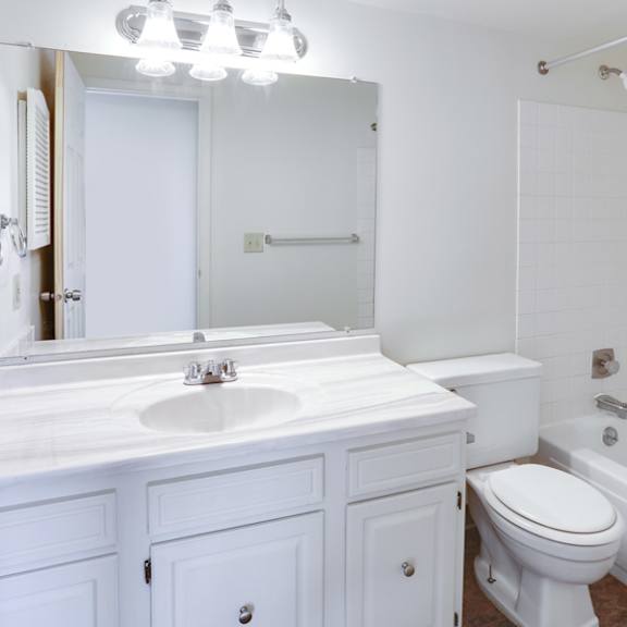 a bathroom with a sink toilet and a tub
