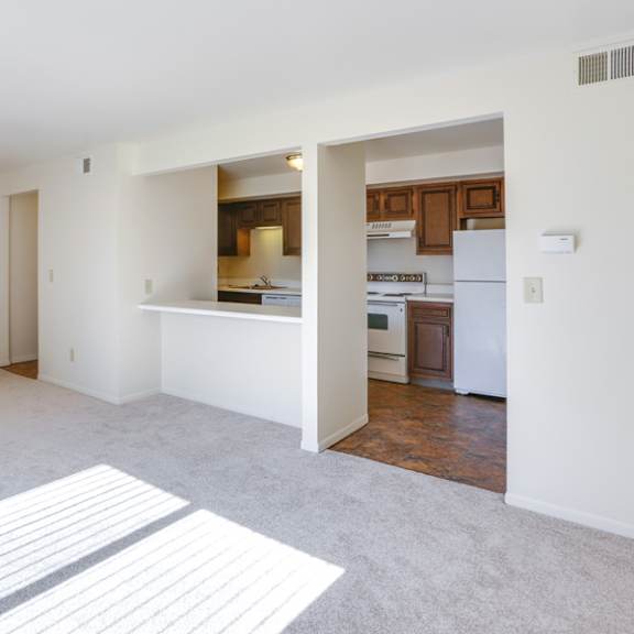 the living room and kitchen of an empty apartment