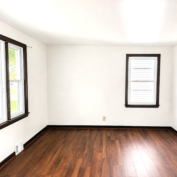 a room with a wooden floor and a window.