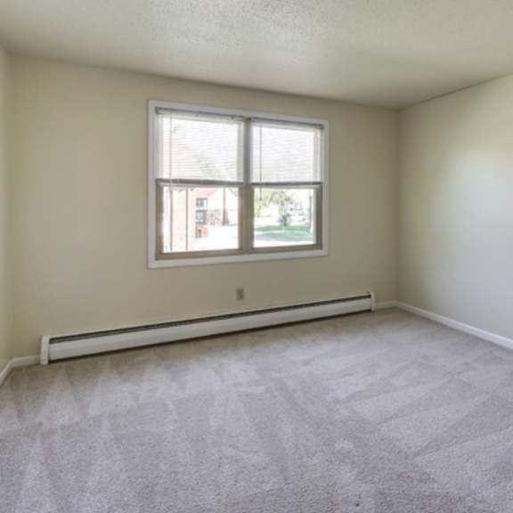 the living room of an empty house with a window