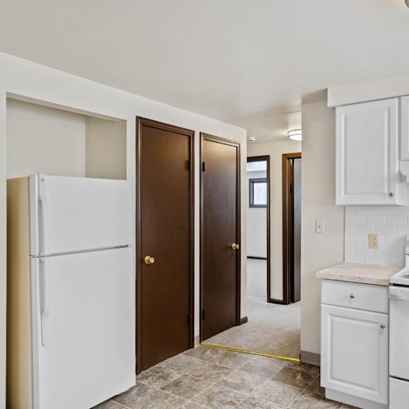 a kitchen with white appliances and cabinets.
