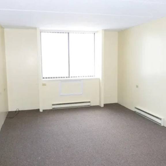a room with a window and a radiator on the wall.