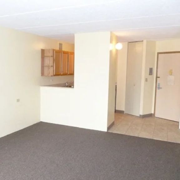 a room with a grey carpet and white walls.