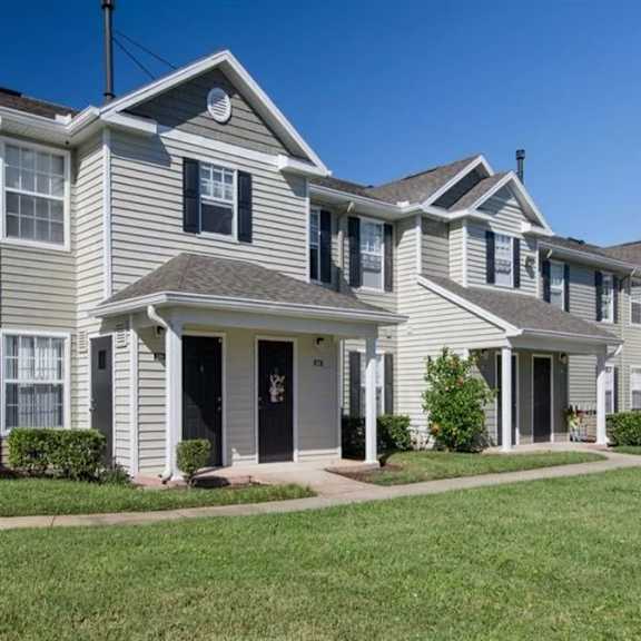 a row of houses with green grass in front of them