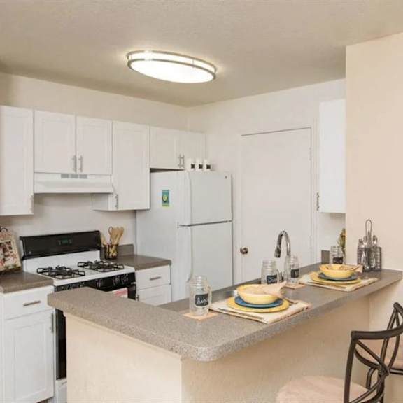 a kitchen with a counter top and a stove top oven
