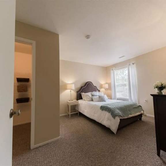 a bedroom with a bed and a window