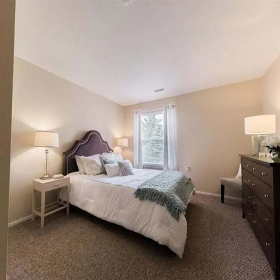 a bedroom with a bed and a dresser