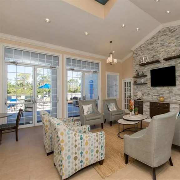 a living room filled with furniture and a flat screen tv