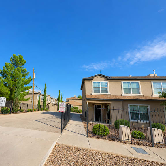 a sunny day at a residential area with a clear blue sky.